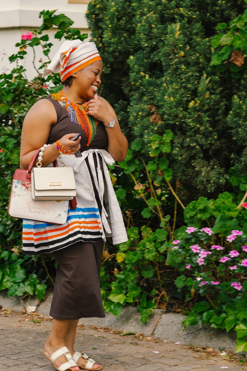 A smiling member arriving at church with her Bible