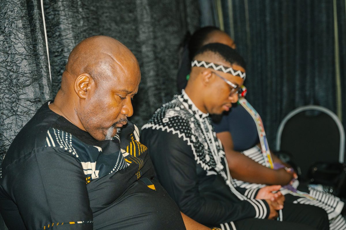 Church leaders with heads bowed in prayer